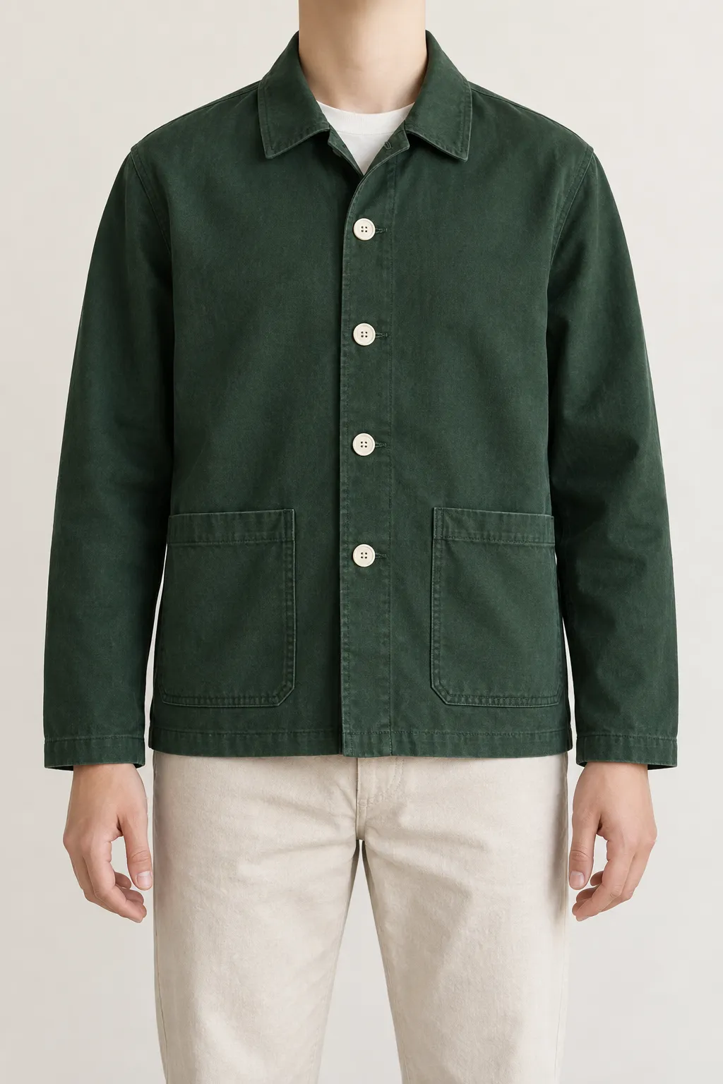Standalone synthetic reference of an adult wearing a plain green jacket against an ivory wall.